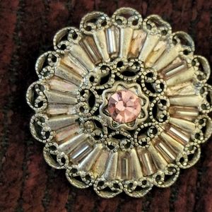 Vintage pin with pink gem in center